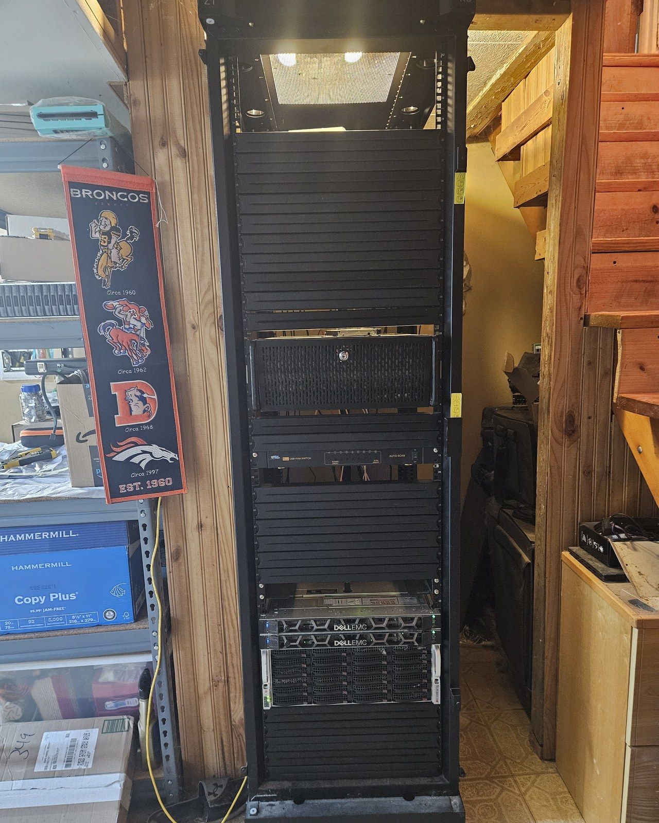 The 42U APC rack: an in-progress 4U AI compute host, KVM switch, a pair of Dell R640s running the Proxmox cluster, and a 36-bay Supermicro storage chassis for Unraid.